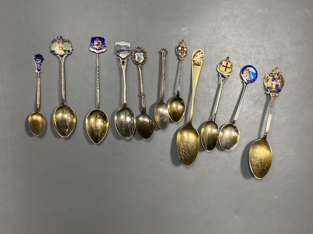 Six 20th century assorted silver and enamel souvenir spoons, gross 81 grams and five similar white metal and enamel spoons,